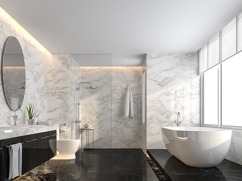 Luxury bathroom with black marble floor and white marble wall 3d render,The room has a clear glass shower partition,There are large windows natural light shining into the room.